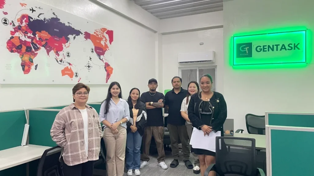 Gentask virtual assistant team standing together inside the office